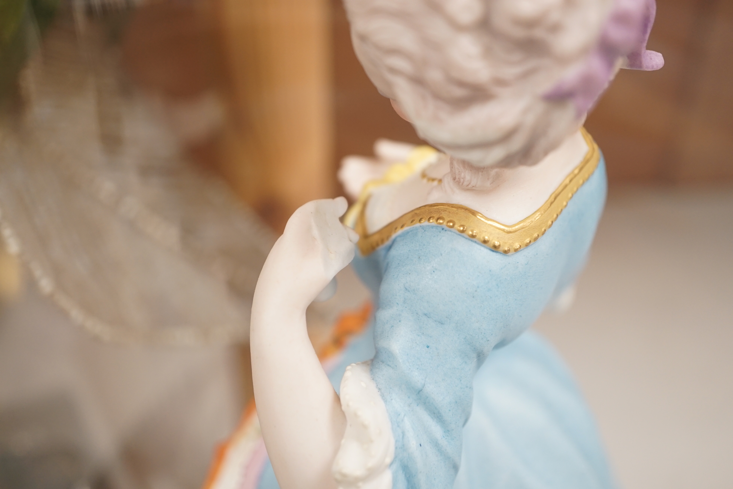 A pair of continental bisque porcelain figures, under glass domes, 48cm overall